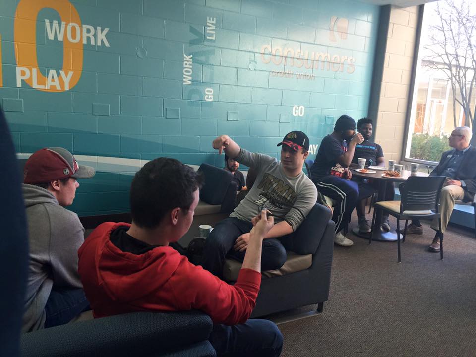 Students sitting and conversing in a lounge area