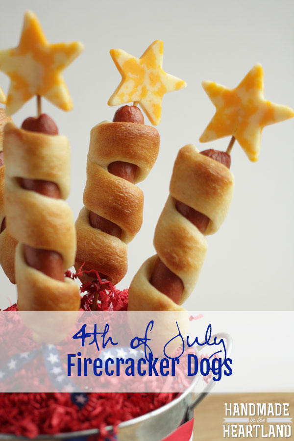 Four hot dogs on skewers with croissant dough baked around it with a cheese star at the top