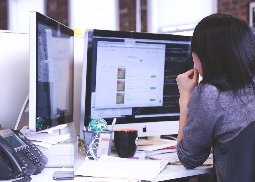 Young lady working on a computer at a desk in an office