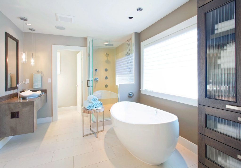 Bathroom with a freestanding tub and glass shower stall