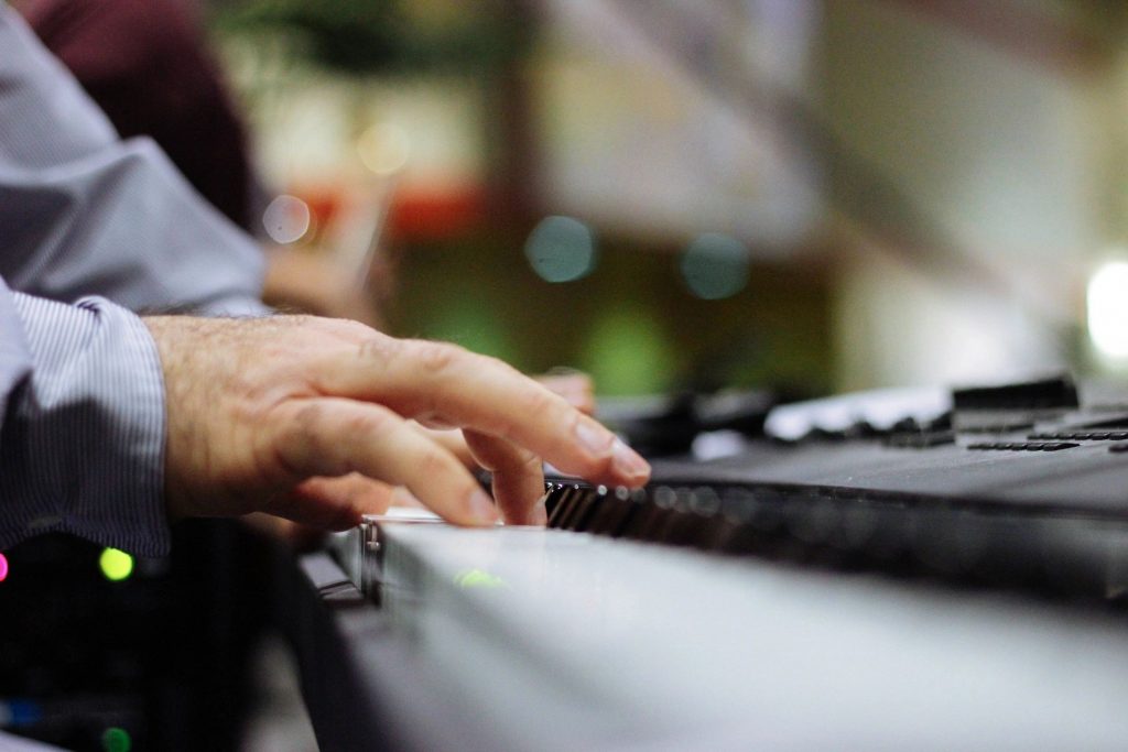 A close-up of a man playing piano