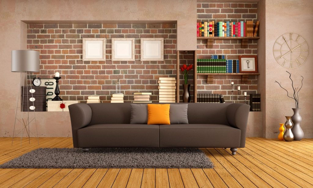 A living room with bookshelves, couch, and floor lamp