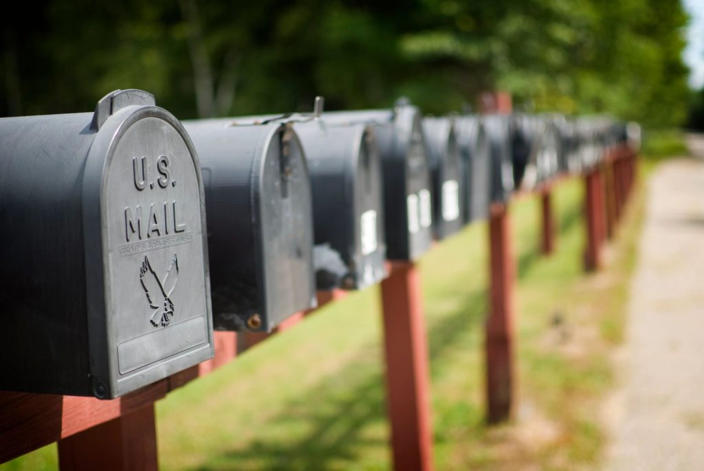 A row of black mailboxes on a sunny day