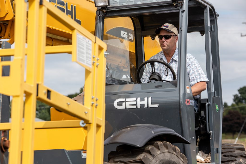 A man driving a heavy construction vehicle outdoors
