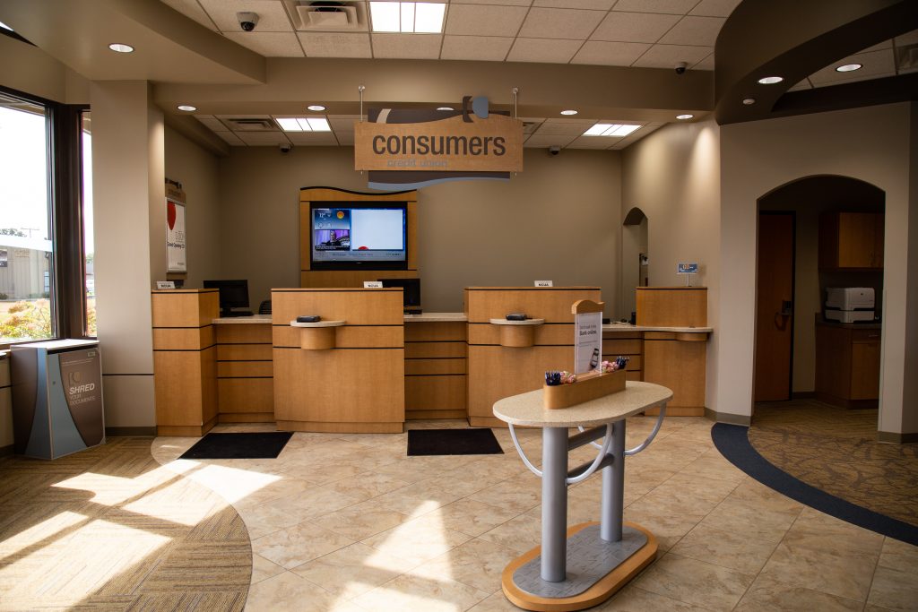 Consumers Credit Union bank teller windows with sunshine coming through windows