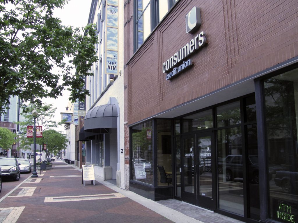 A Consumers Credit Union storefront in a downtown area