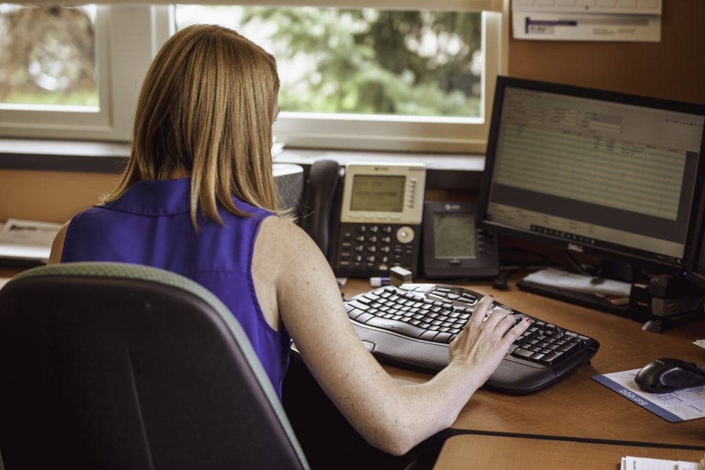A woman working with spreadsheet on her computer