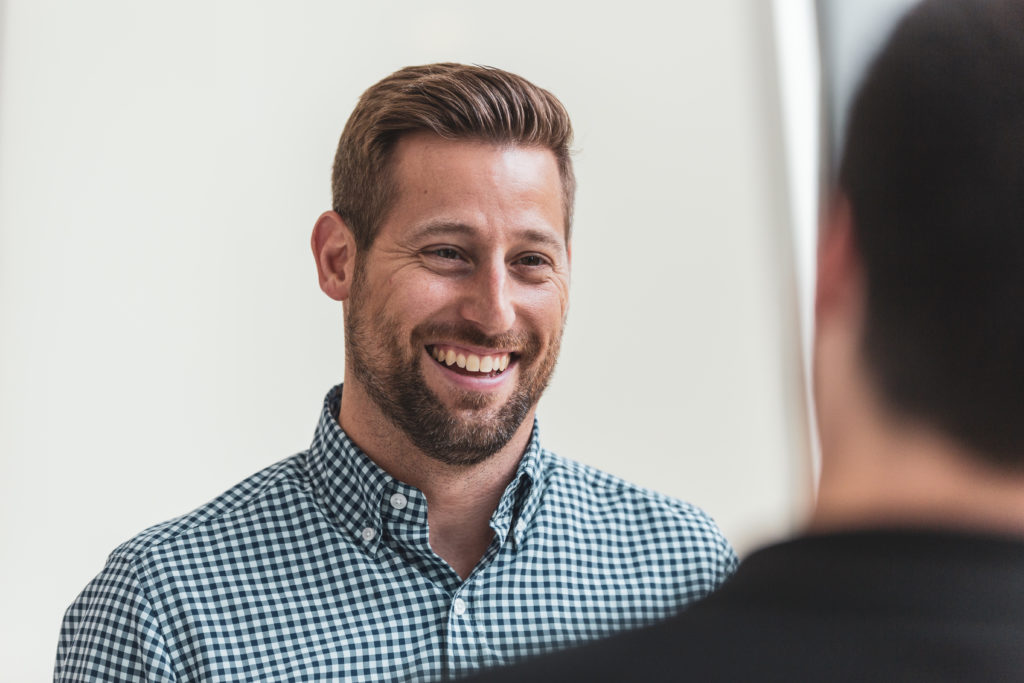 Gregg Teegardin, Grand Rapids Mortgage Market Manager smiling while speaking to someone.