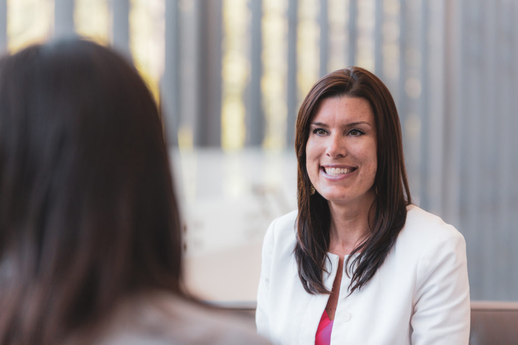 Consumers Credit Union Mortgage Loan Officer, Mary Brown, smiling while speaking to another lady.
