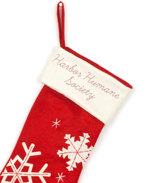 Harbor Humane Society red Christmas Stocking with snowflake designs.
