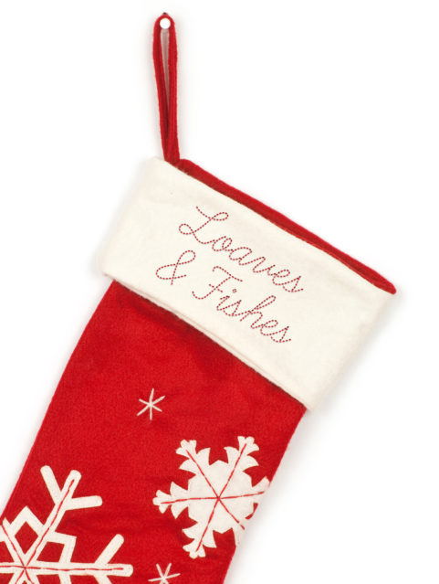 Loaves & Fishes red Christmas Stocking with snowflake designs.