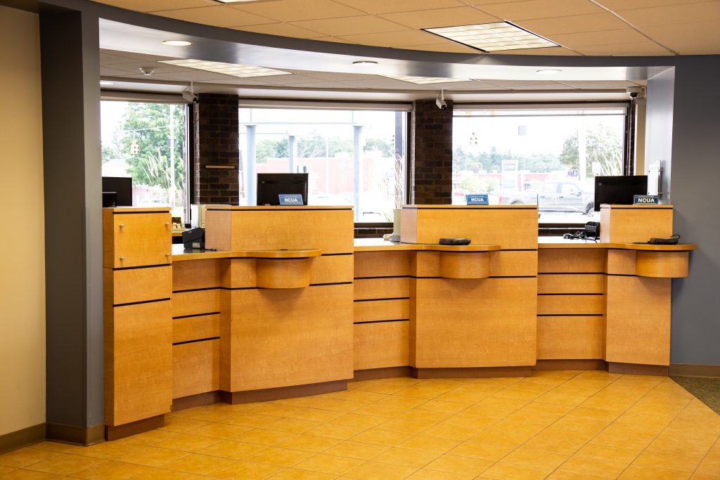 A Consumers Credit Union lobby with three teller windows.