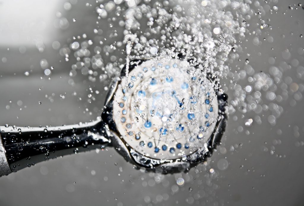 A shower head spraying water.