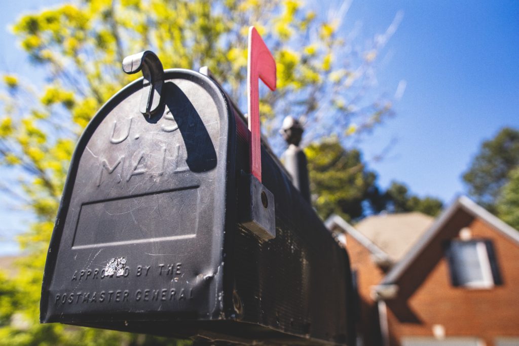 Up close of black mailbox with red flag.