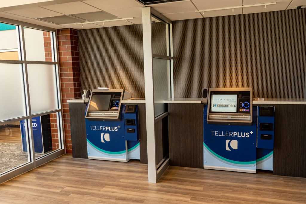 Two interactive tellers inside of a Consumers Credit Union office location.