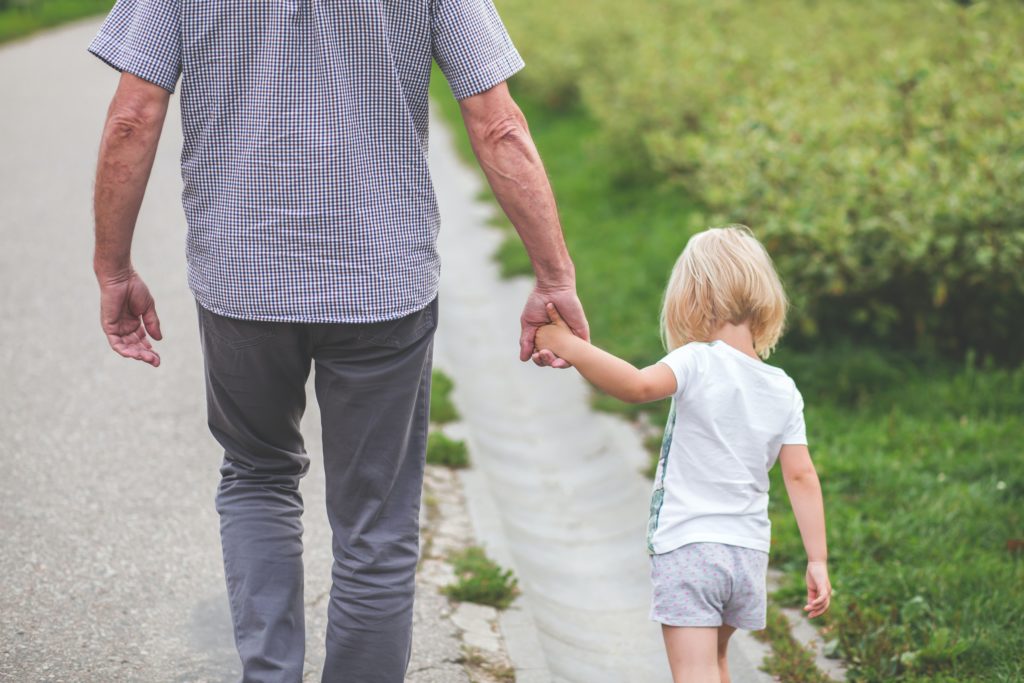 Man walking with small child