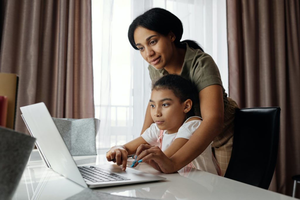 Women and girl on laptop