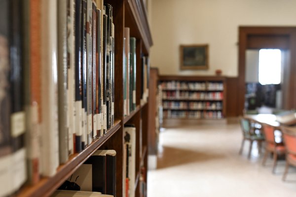 Up close shot of a bookshelf in a college library