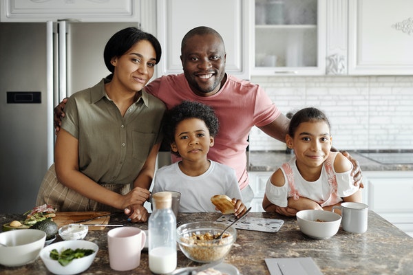 Smiling family in a white kitchen