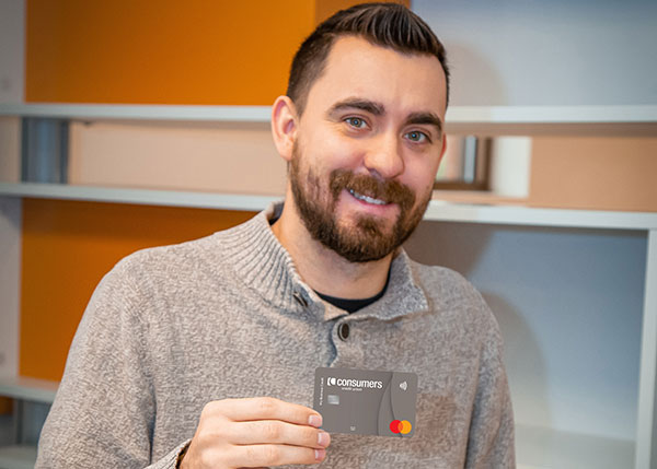 Matt Baker holding a business rewards credit card