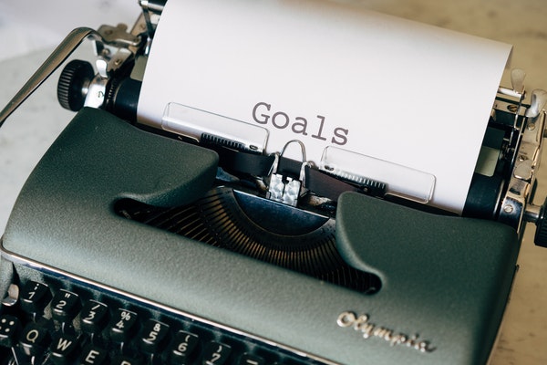 "Goals" typed out on a paper coming out of a typewriter