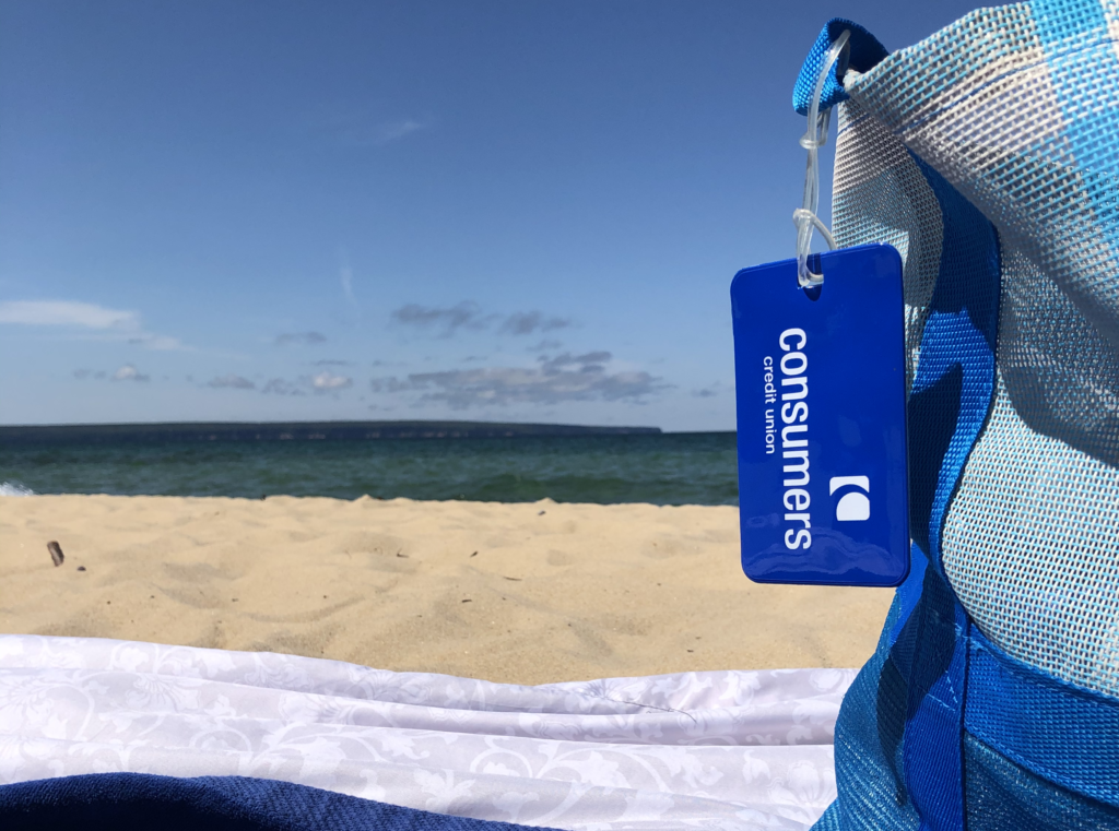 A Consumers Credit Union beach bag on Miner's Beach in Munising, Michigan.