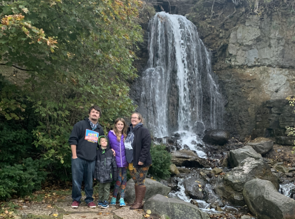A family in front of a waterfall in Petoskey, Michigan.