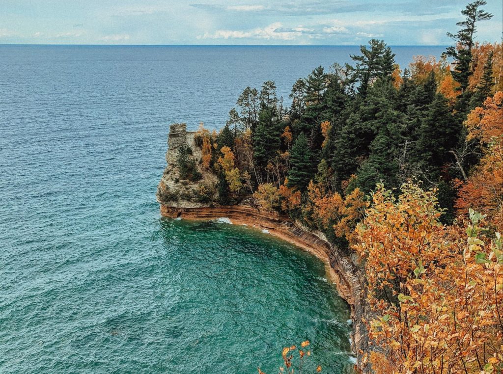 Trees on the shore of the Pictured Rocks National Lakeshore in Munising, Michigan during autumn.