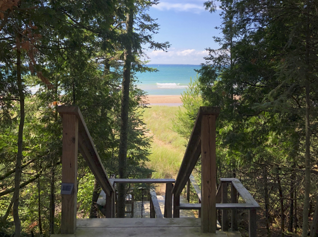 A wooden staircase leading down to the water in Cross Village, Michigan.