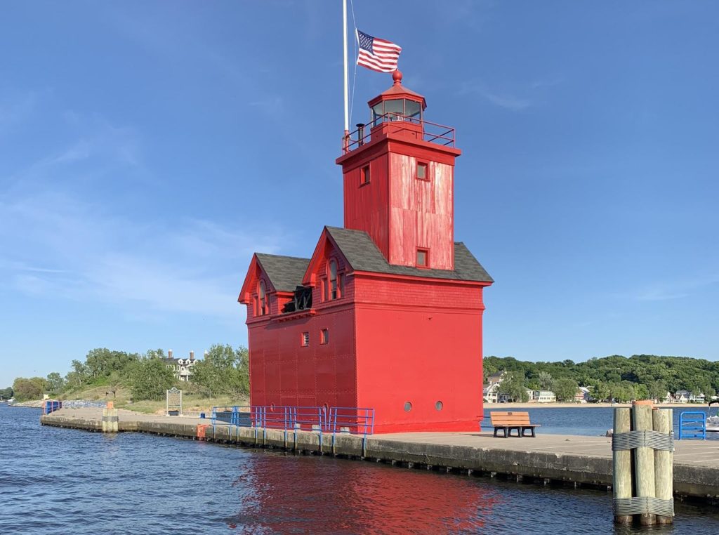 A red lighthouse on a pier in Holland, Michigan.