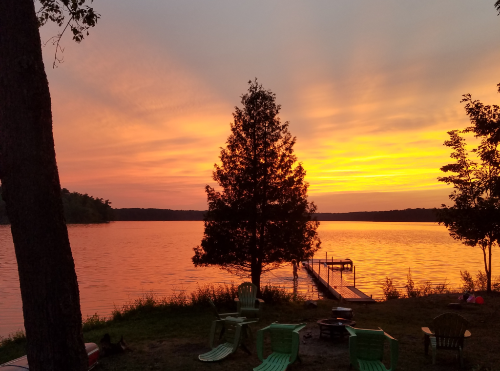 Sunset on a peaceful lake in Muskegon, Michigan in the summer.