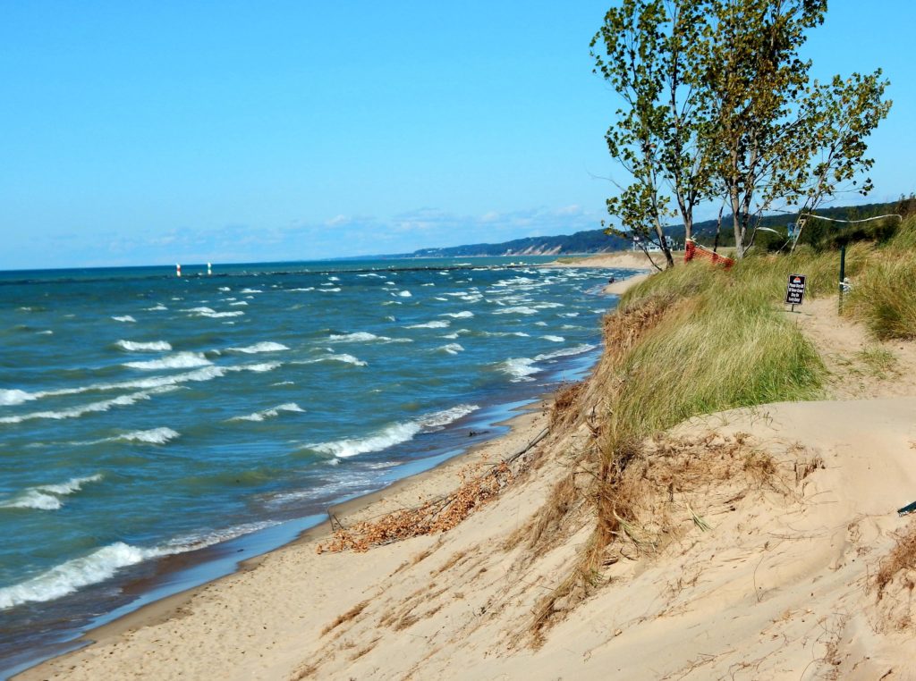 A sandy shore on Oval Beach in Saugatuck, Michigan on a sunny day.