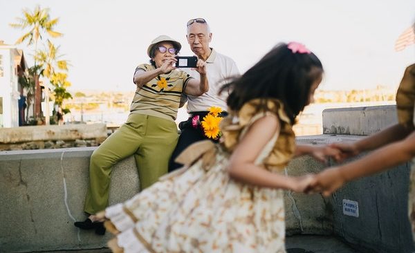 older couple photographing granddaughters