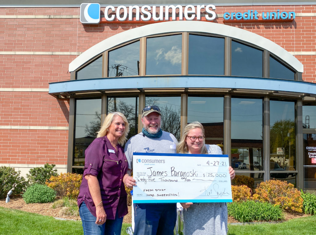 James Baranoski and wife accept $25,000 Fresh Start Home Sweepstakes grand prize with Kim Ferris at Consumers Credit Union Milwood Office.