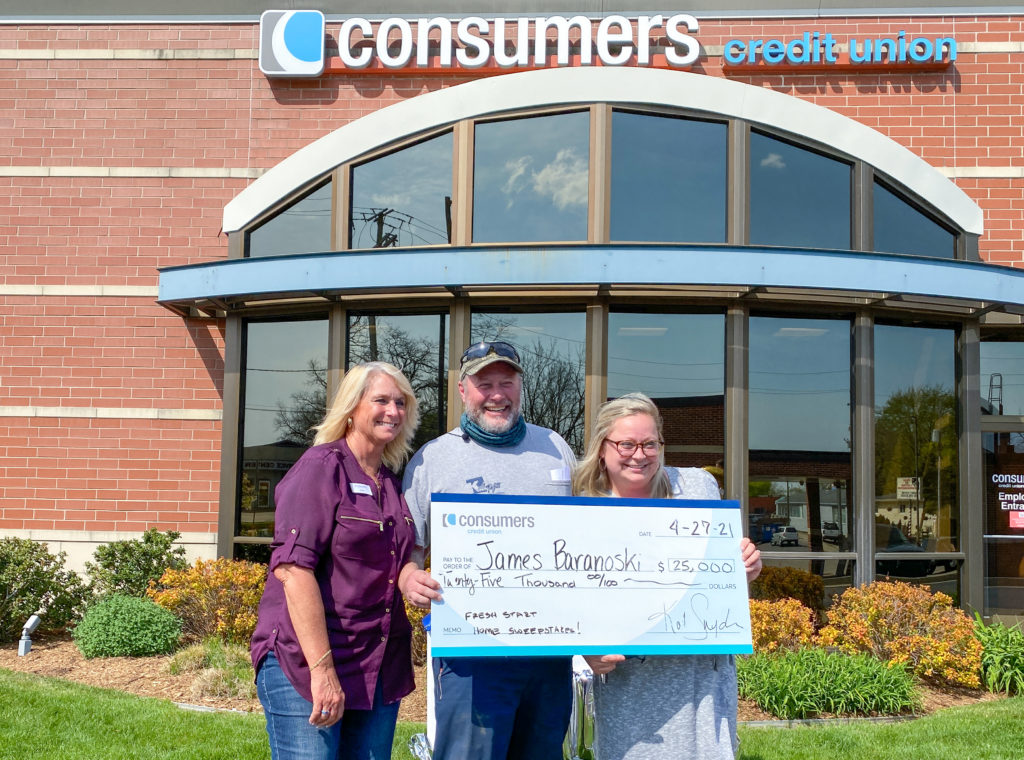 James Baranoski and wife accept $25,000 Fresh Start Home Sweepstakes grand prize with Kim Ferris at Consumers Credit Union Milwood Office.