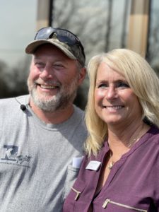 James Baranoski and Kim Ferris smile outside of Consumers Credit Union Milwood Office