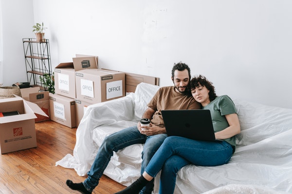Couple in the process of moving planning on a futon