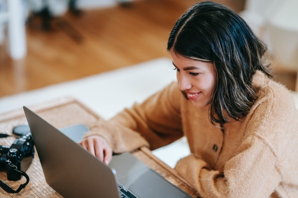 Woman interviewing for a job via a laptop.