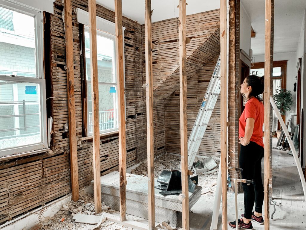 A woman assessing the construction of a room in her house.