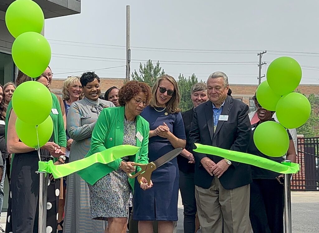 Women's Resource Center CEO Sandra Gaddy cuts the ribbon to celebrate the grand opening of their new location in Grand Rapids, Michigan.