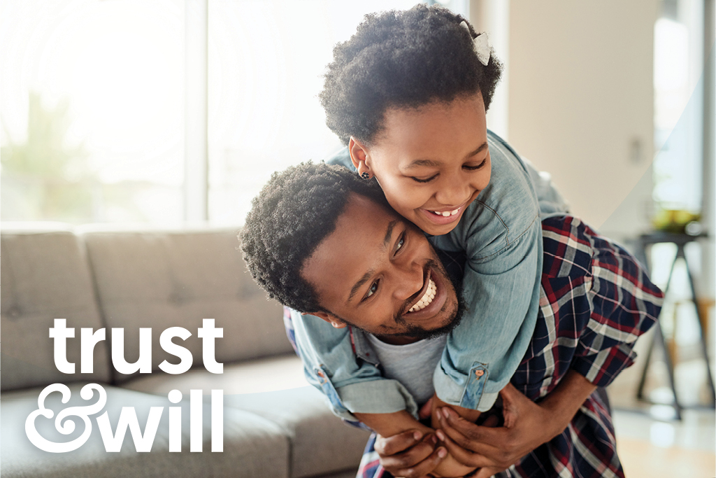 Black father holds carries his daughter on his back smiling