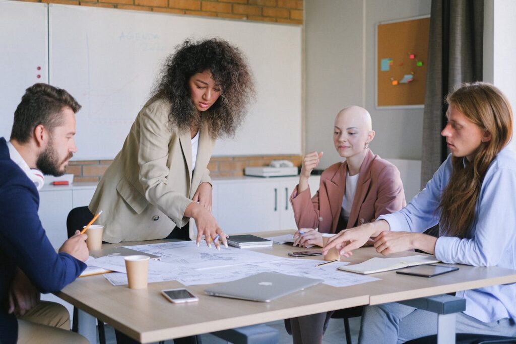 Group of people sitting around a table having a meeting.