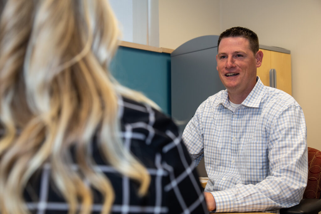 Josh Summerfield speaking with a member