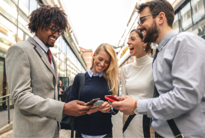 Group of people standing around networking.
