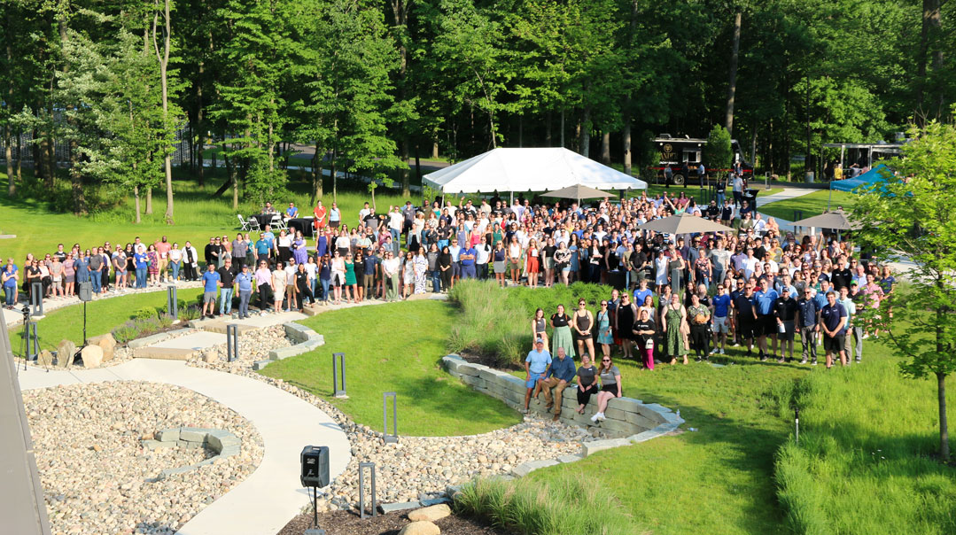 Large group enjoying outdoor networking event.