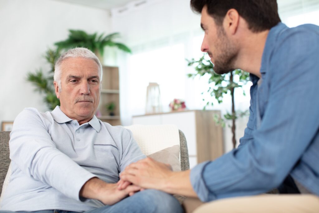 Father and son sitting together and talking.