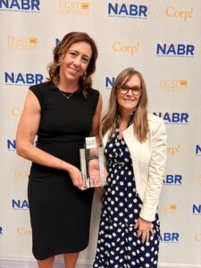 Consumers team members standing together with their award