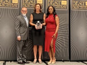 Consumers team members standing together with their award.