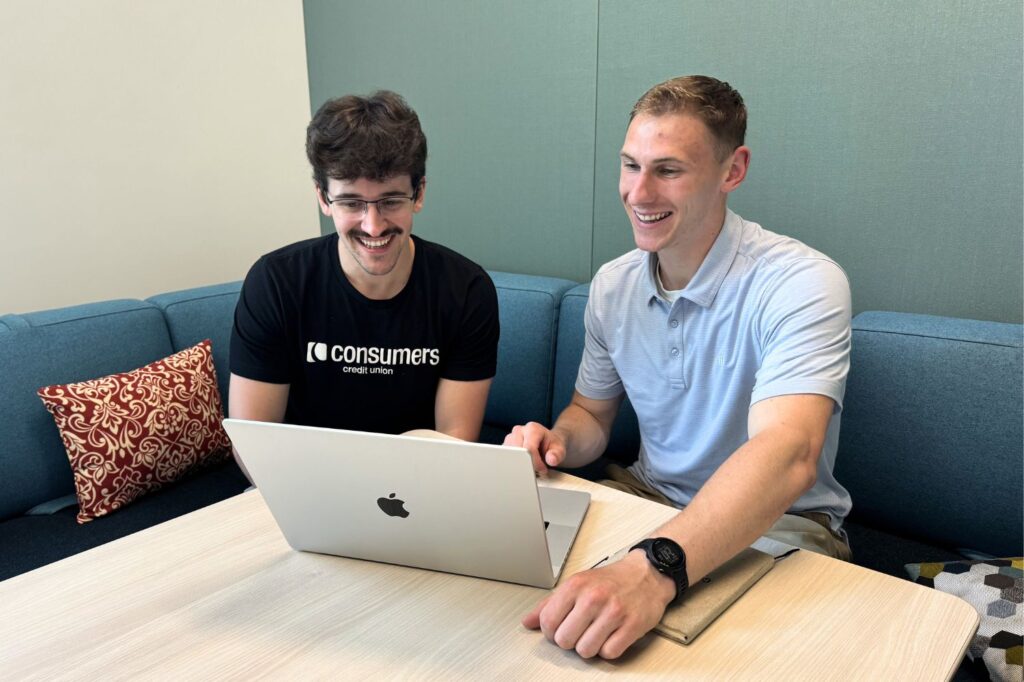 Two Gen Z employees sitting together and collaborating