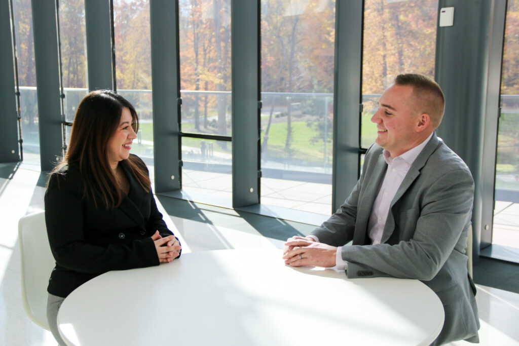 Business services team members smiling while talking to each other.